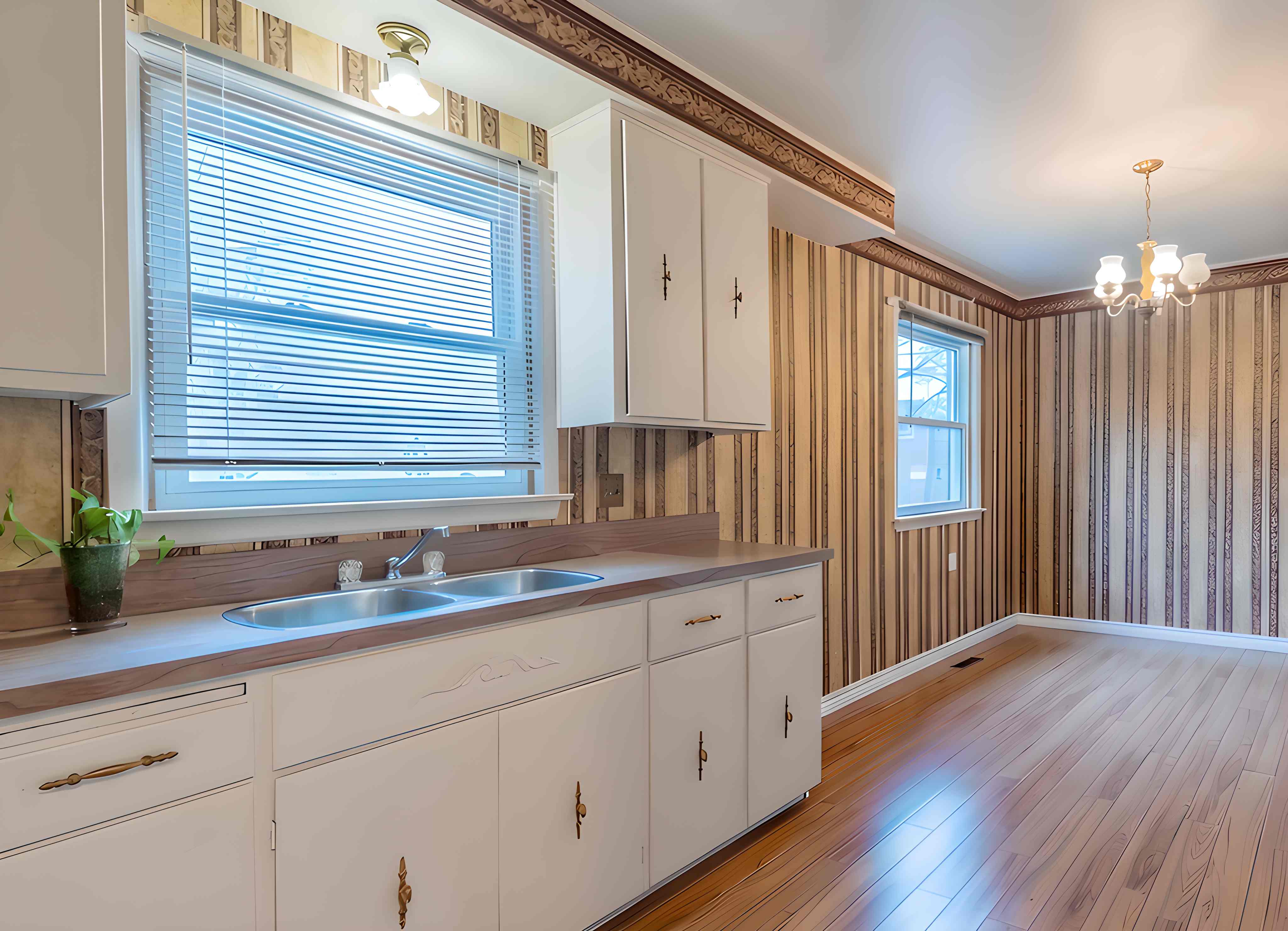 Dated kitchen with striped wallpaper and gold hardware before renovation